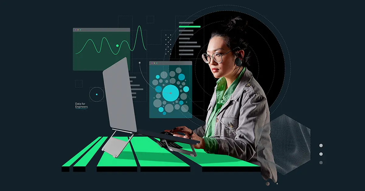 Employee sitting at desk, gray and green background